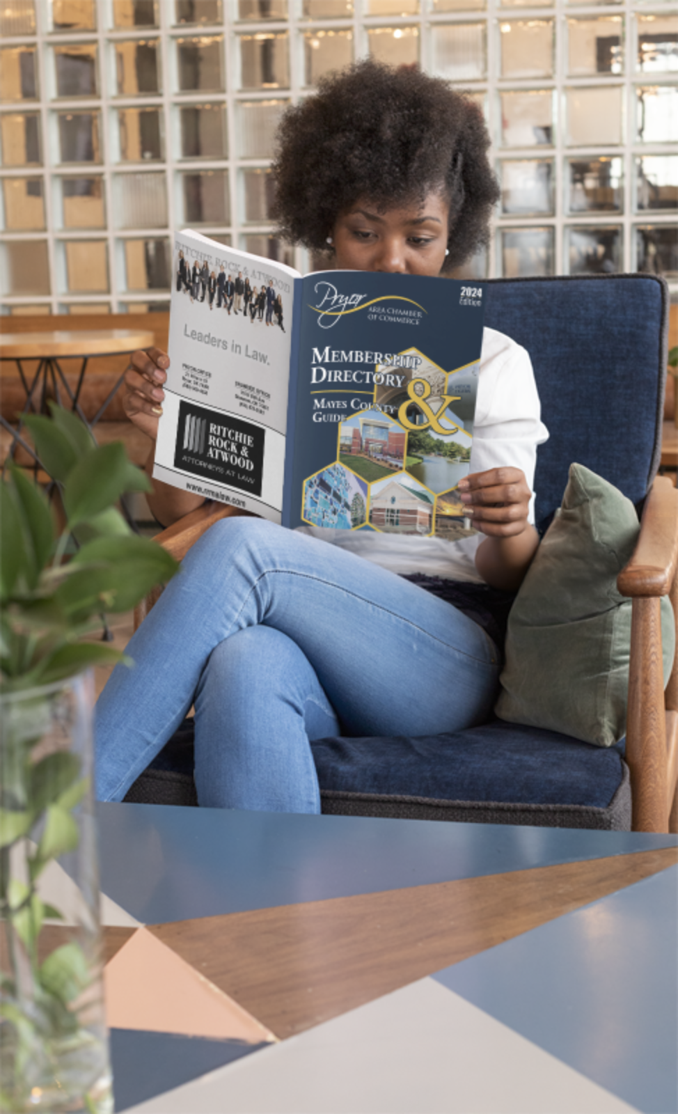 Person reading a chamber guide featuring community businesses and services